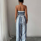 👗💙 Geometric jumpsuit with halter neckline and side slit!