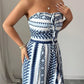 👗💙 Geometric jumpsuit with halter neckline and side slit!